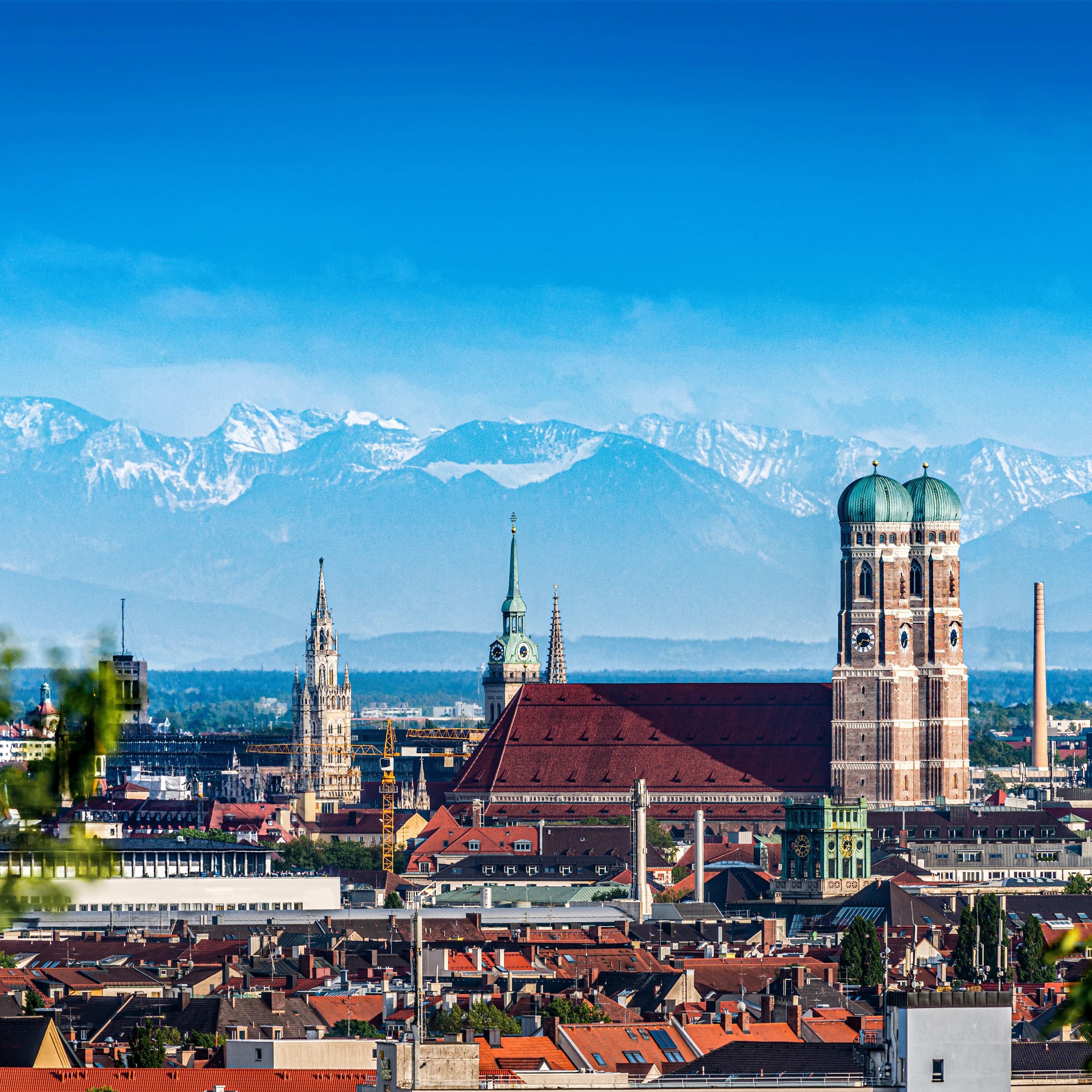 The old town of Munich with the mountains in the background.