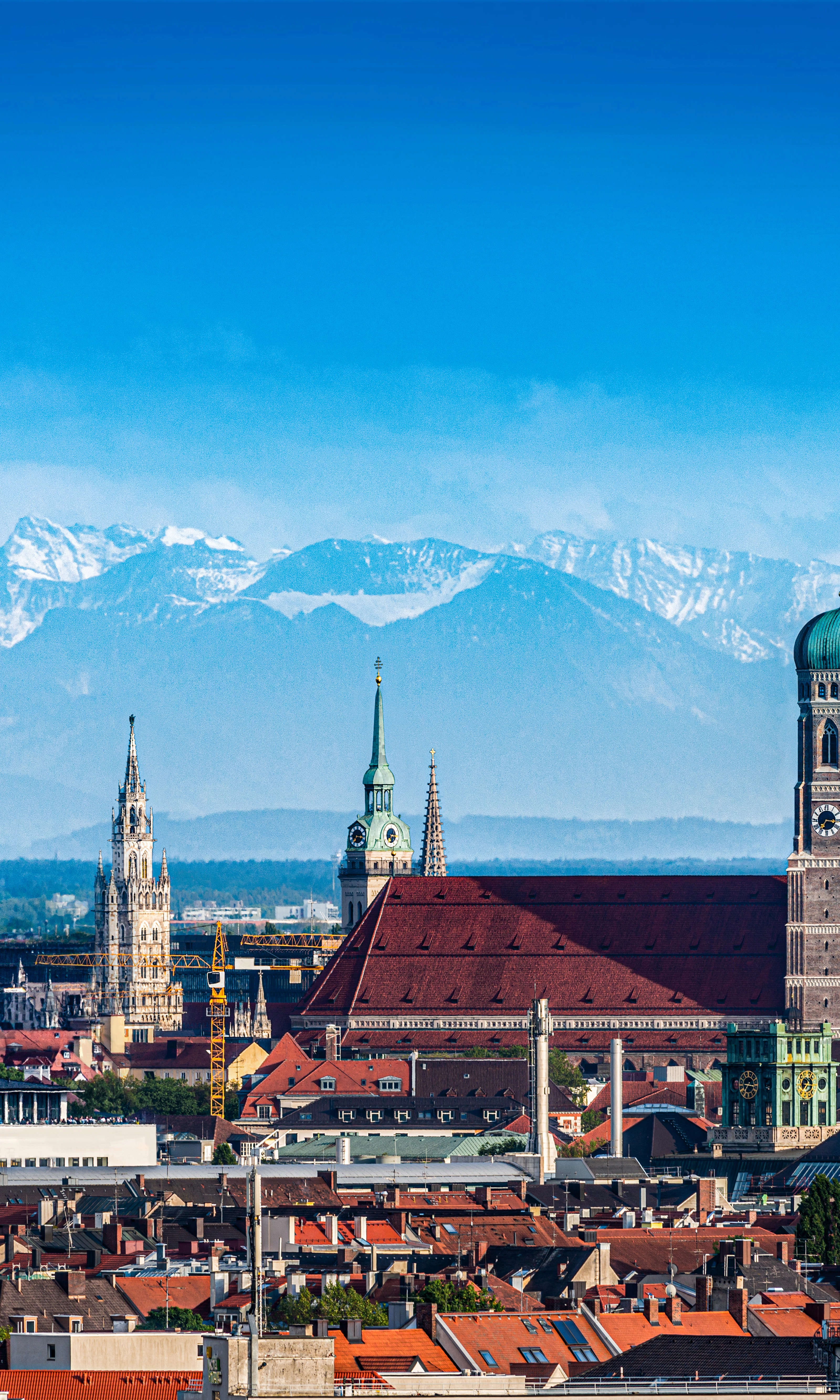 The old town of Munich with the mountains in the background.