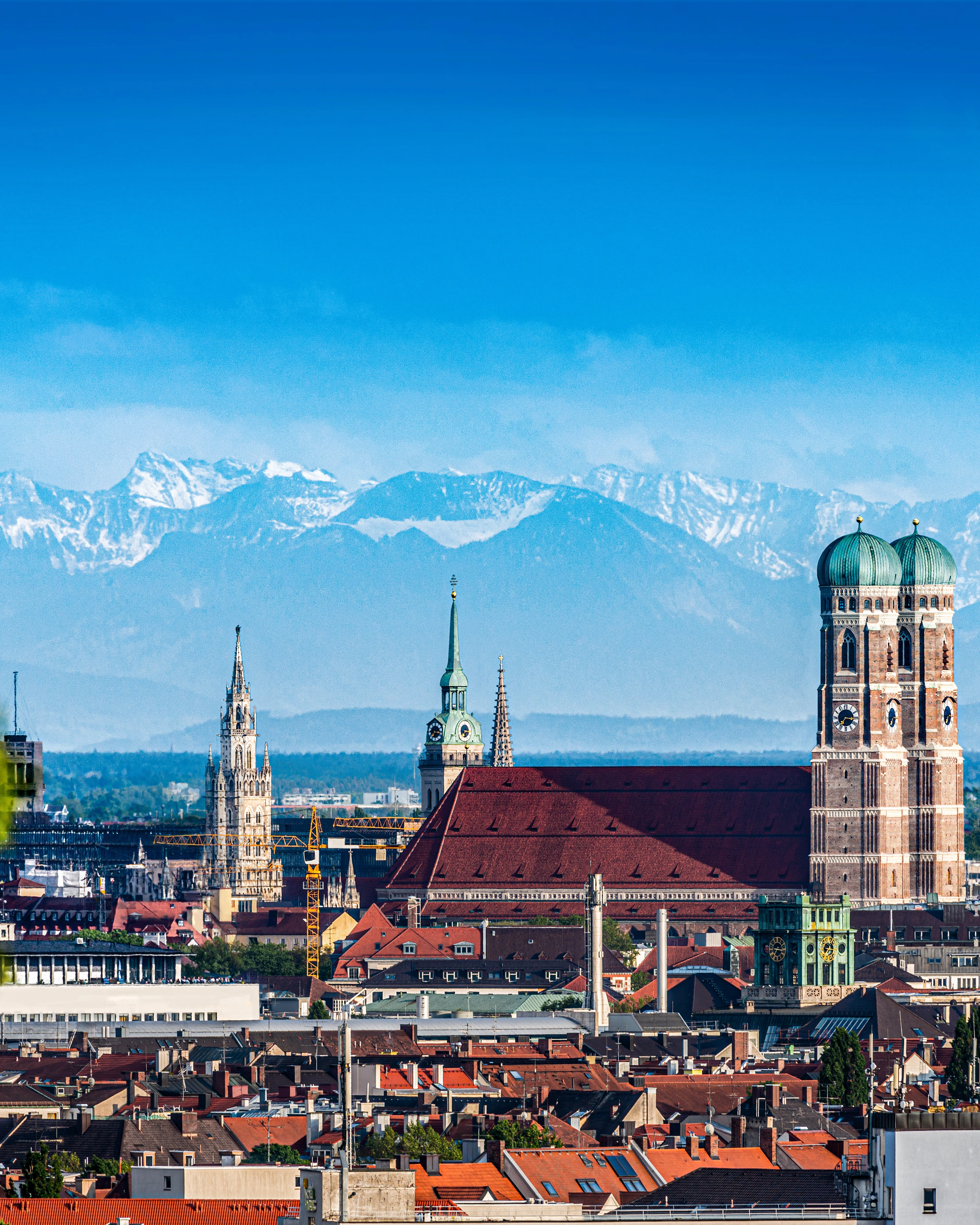 The old town of Munich with the mountains in the background.