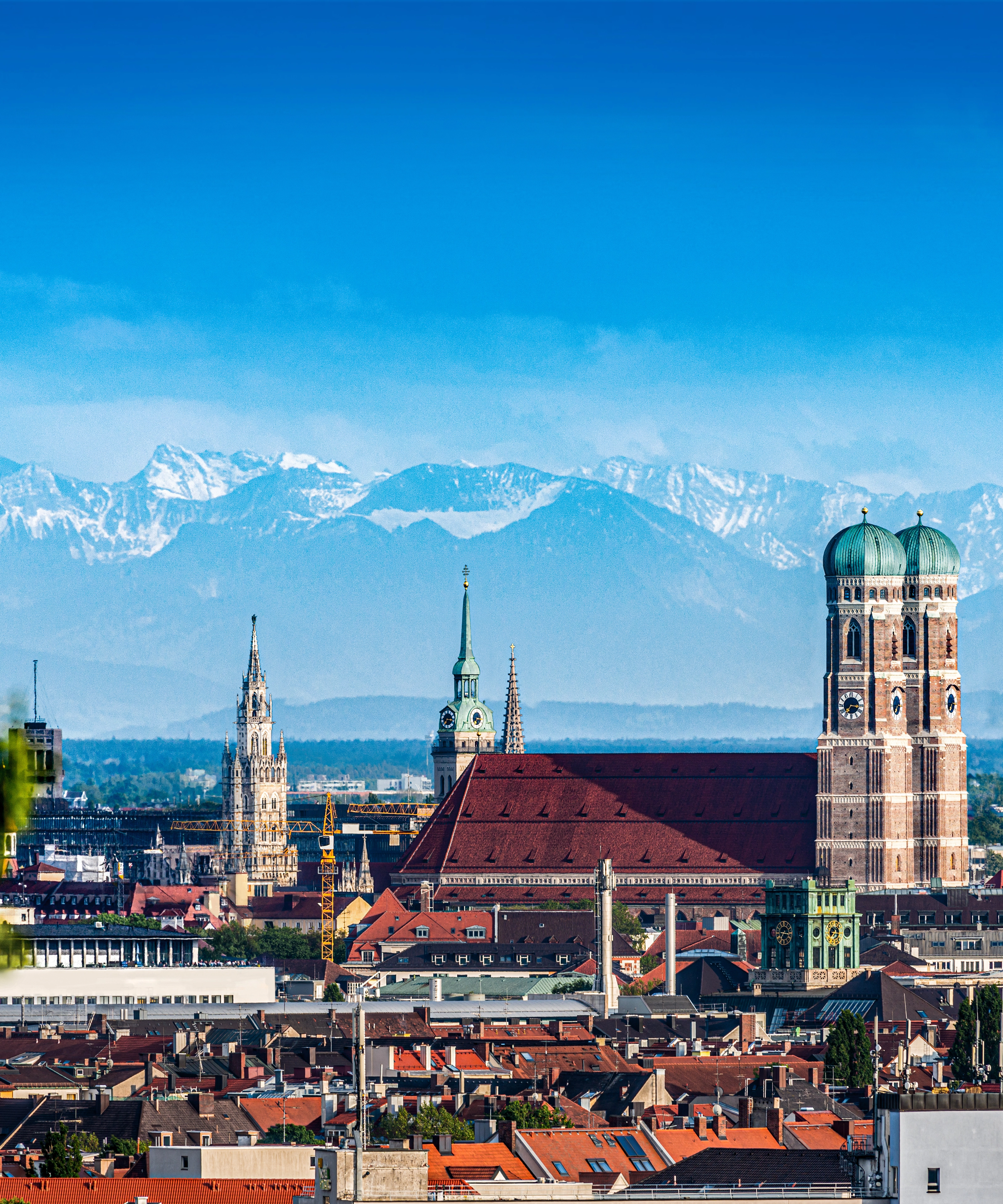 The old town of Munich with the mountains in the background.
