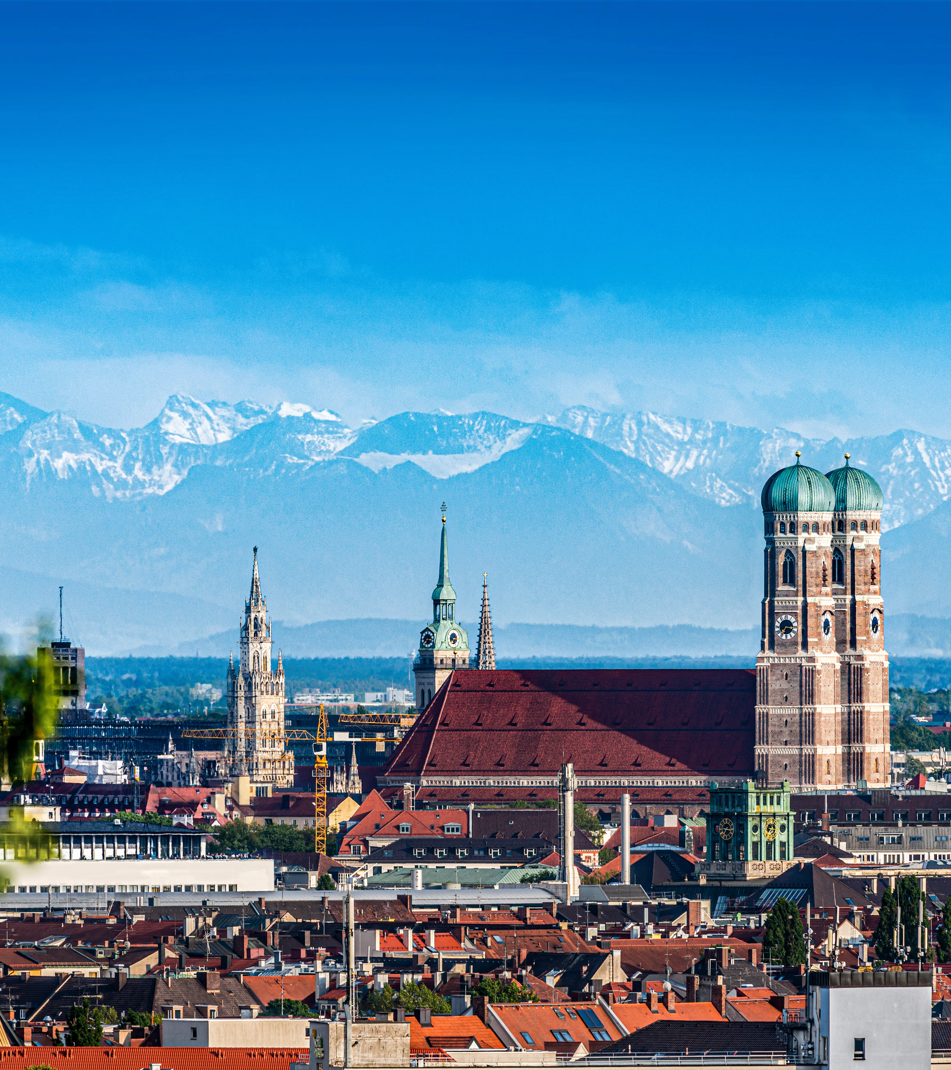 The old town of Munich with the mountains in the background.
