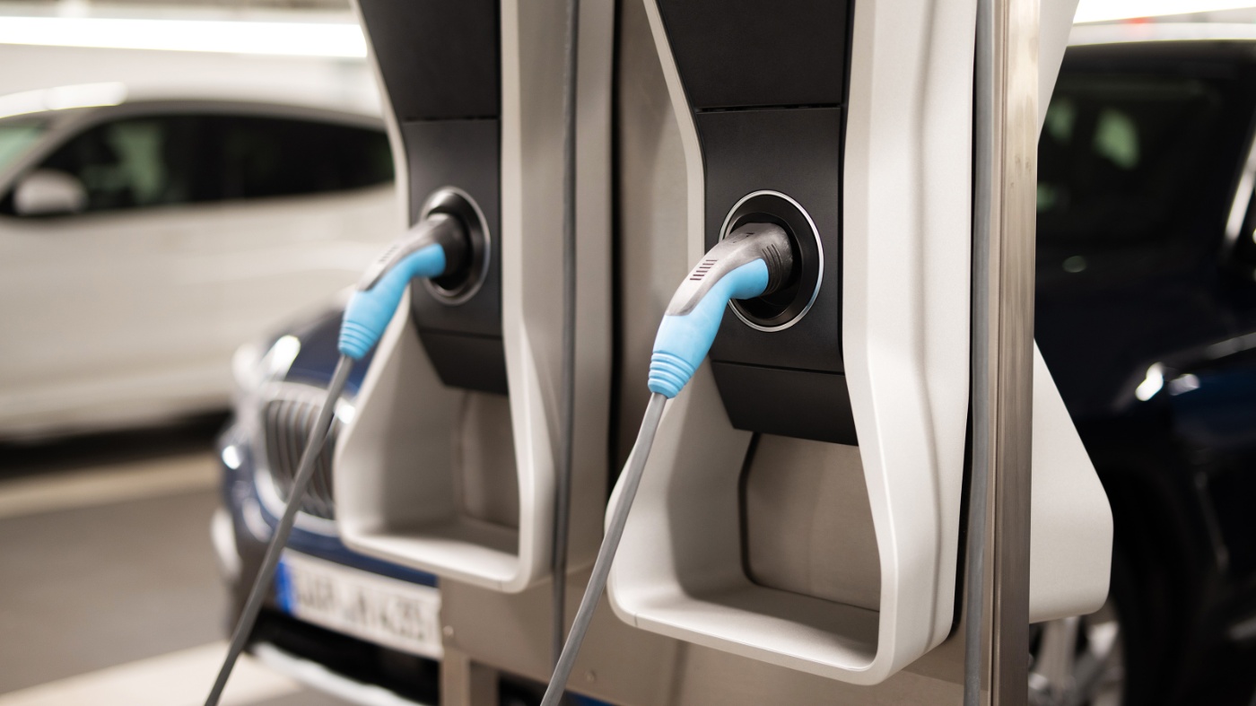 Nahaufnahme von Ladekabeln an E-Auto-Ladesäulen in einer Tiefgarage.